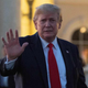 Donald Trump waves at the Trump International Golf Club as he arrives for a Super Bowl viewing party in West Palm Beach on February 2, 2020.